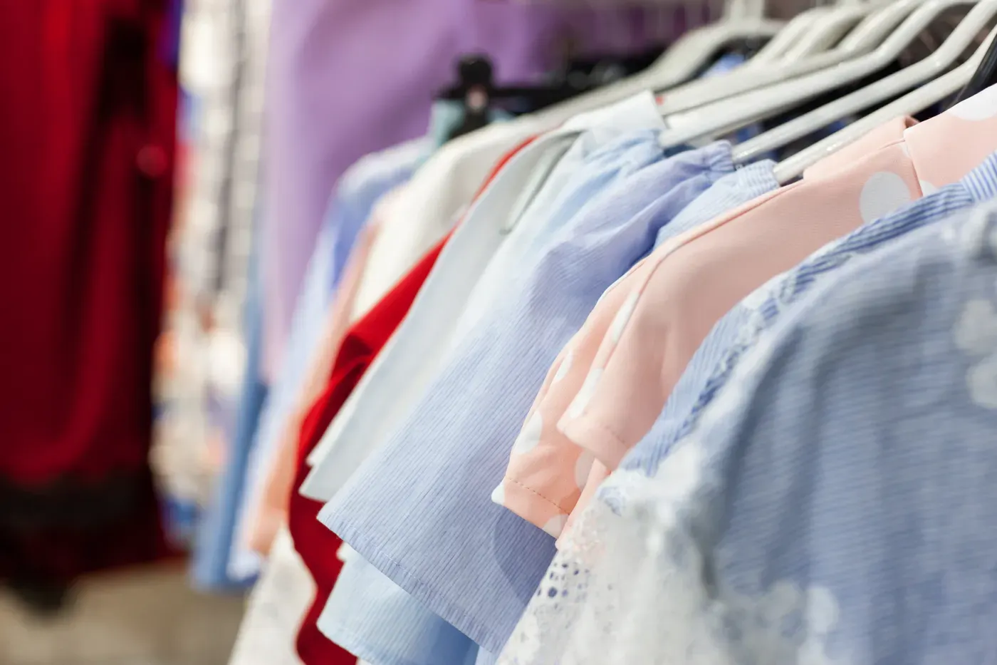Pastel blouses and clothing on a boutique rack